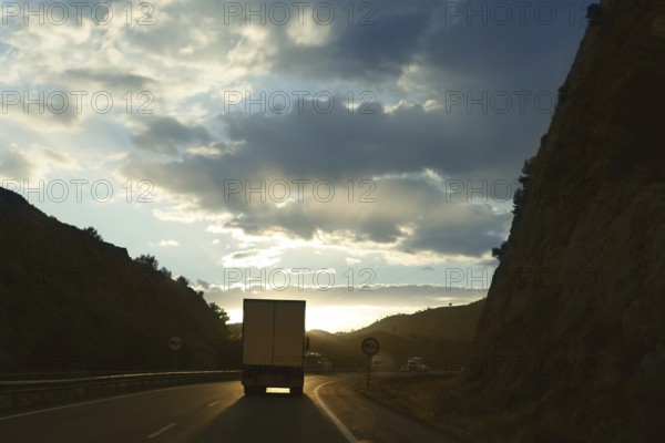Lorry truck backlight on a golden Europe road evening