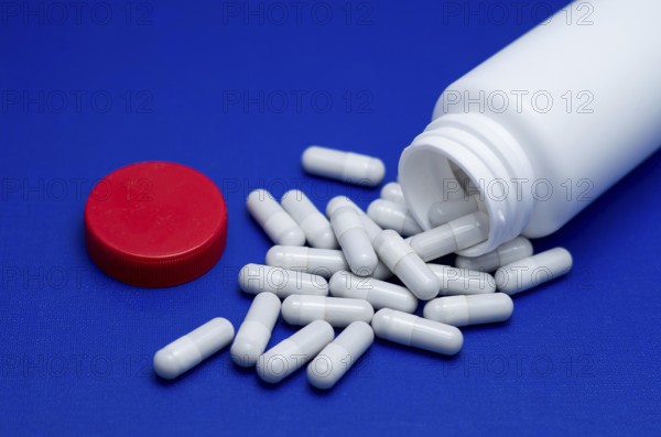Large white pills fell from a large white bottle. Life without drugs and dependence on capsules of antibiotic, medicine, amphetamines, drugs and drugs. Concept of drug withdrawal drugs. Bulgaria
