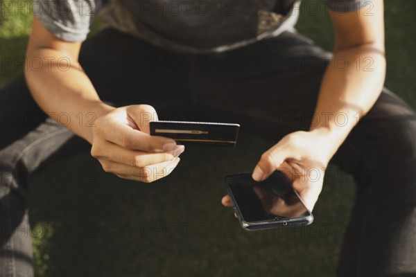 A man online shopping using credit card and Mobile phone for online shopping, technology and internet concept