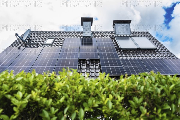 Solar panels and solar thermal energy on the roof of a detached house in Essen, Germany, Europe