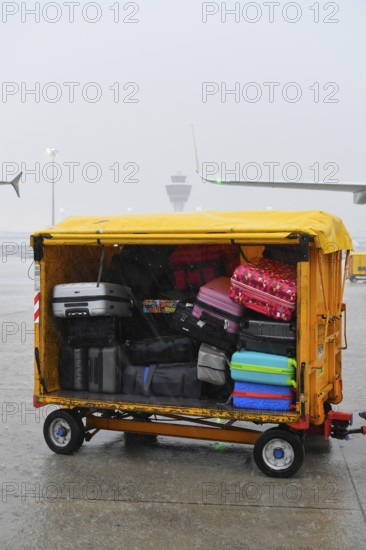 Baggage with baggage tag with control tower during thunderstorm, heavy rain, rain cloud, storm, Munich Airport, Upper Bavaria, Bavaria, Germany, Europe