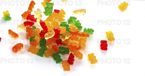 Gold Bears or Gummy Bears falling against White Background