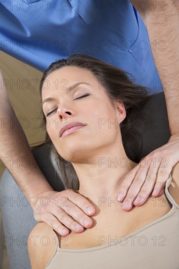 Myofascial therapy on beautiful woman shoulders by therapist hands