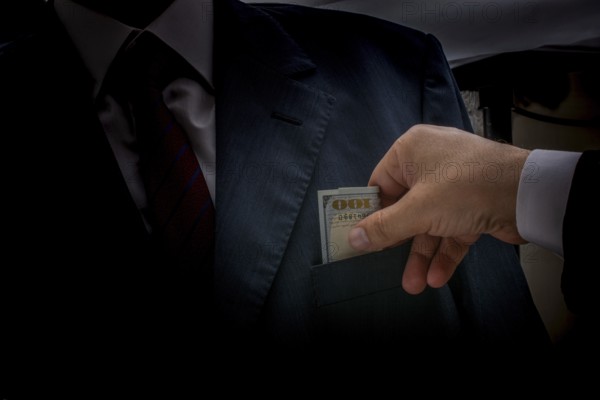 Concept for corruption and bribing fraud finance with Bundle of dollar