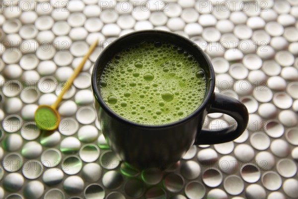 Matcha green tea from Japan on modern stainless steel background