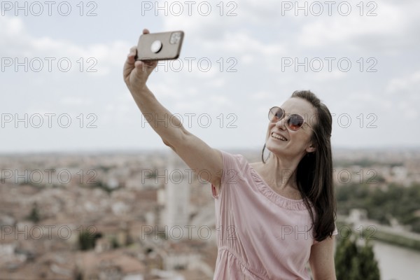 Woman taking a selfie, Verona, Italy, Europe