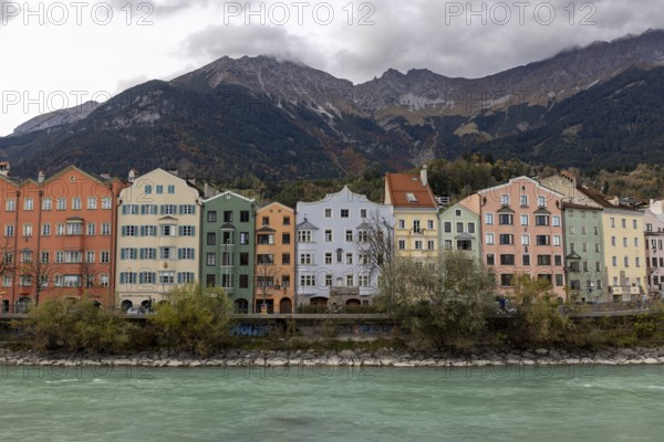 Colourful row of houses on Mariahilfstrasse on the Inn, Tyrolean Alps in the background, Innsbruck, Tyrol, Austria, Europe