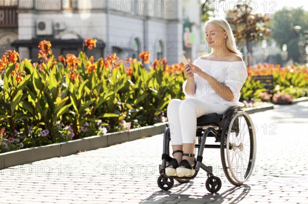 Woman wheelchair city using smartphone with copy space
