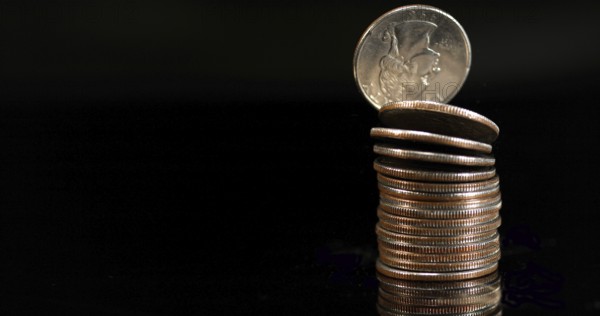 Quarter Dollar Coins Falling, Rolling and Sliding on Black Background
