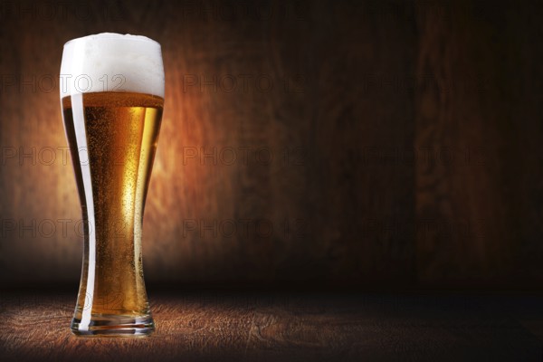 Glass beer on wood background with copyspace