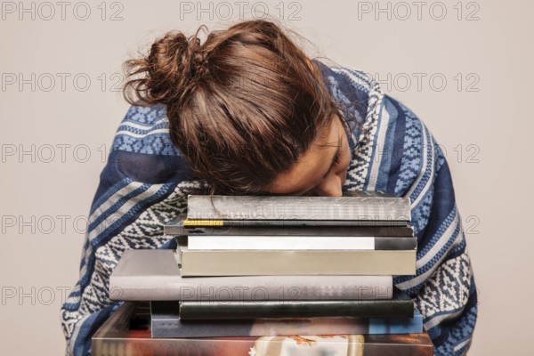 girl sleeping pile books. High resolution photo