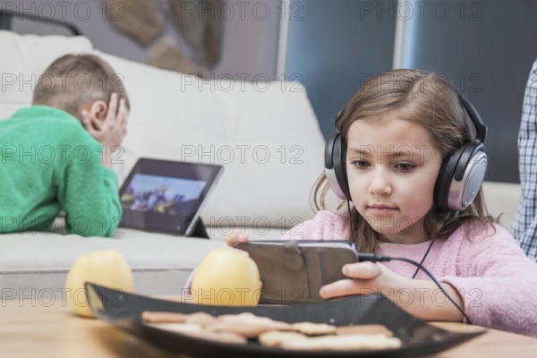 Kids using technologies living room