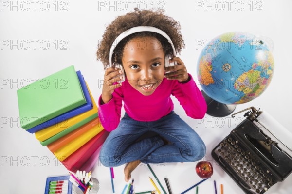 Girl headphones with study tools studio