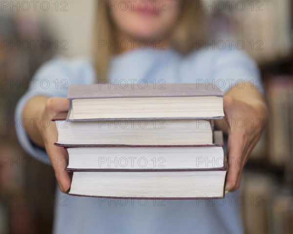 Close up woman holding books