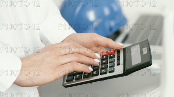 Close up hands holding calculator