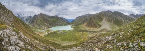 Beautiful panorama of Sheshnag lake in Kashmir mountains in India on cloudy day