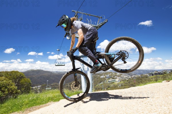 Mt Buller, Australia, January 2 2018: Downhill mountain bike riders attempt the ABOM and International tracks on a hot summer's day, Oceania