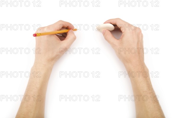 Left-handed person with pencil and eraser