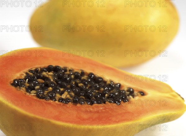 PAW PAW OR PAPAYA (carica papaya) FRUIT AGAINST WHITE BACKGROUND