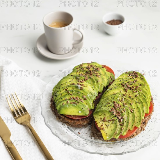 High angle avocado toast plate with cutlery coffee