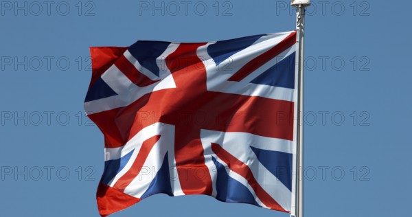 British Flag Waving in the Wind against blue sky