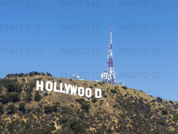 The Hollywood Sign (formerly the Hollywoodland Sign) is a landmark and American cultural icon located in Los Angeles, California. It is situated on Mount Lee in the Hollywood Hills area of the Santa Monica Mountains. The sign overlooks the Hollywood dist