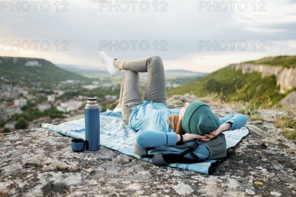 Traveller with beanie relaxing outdoors. Beautiful photo
