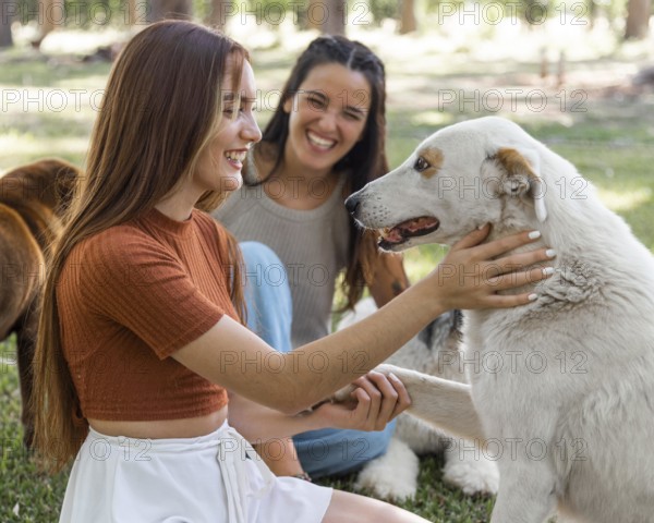 Women playing with dog