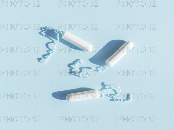 Menstrual tampons with thread blue background