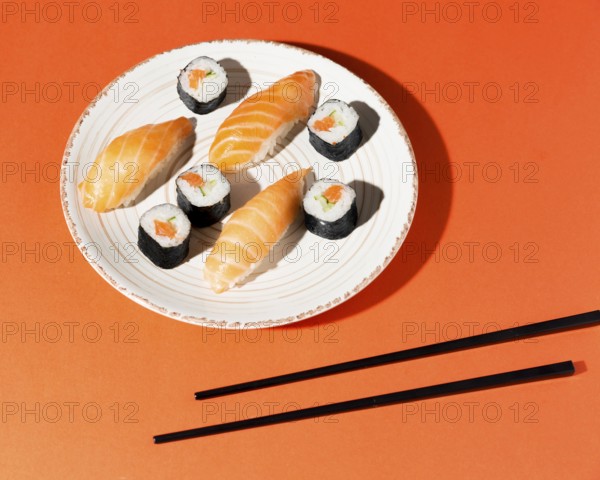 Plate with delicious variety sushi chopsticks