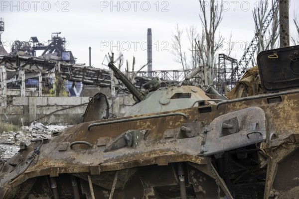 Burnt tank and destroyed buildings of the Azovstal plant shop in Mariupol war in Ukraine with Russia