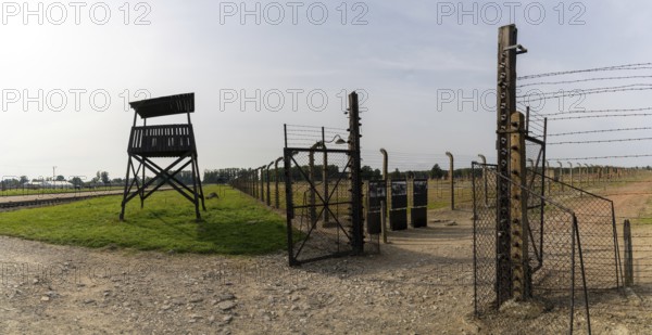 Auschwitz, Poland - 15 September, 2021: guard tower and prison camp gate at Auschwitz concentration camp in Poland