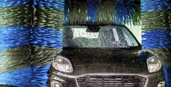 A vehicle in an automatic car wash