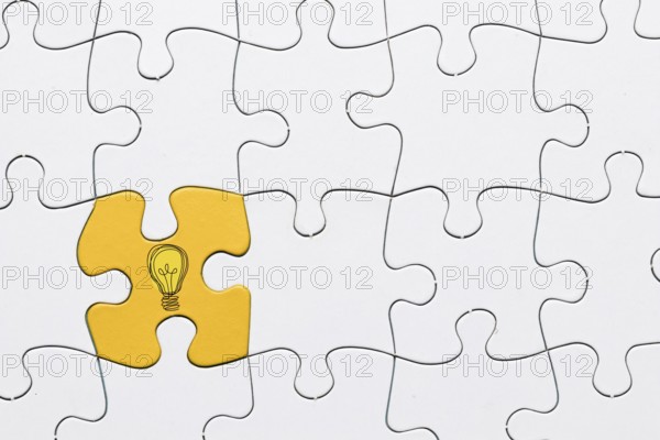 Idea icon yellow puzzle piece connected with white grid puzzle backdrop. Resolution and high quality beautiful photo