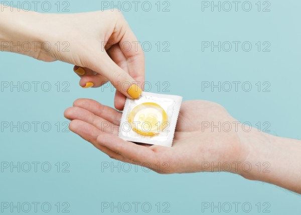 Woman giving condom another person