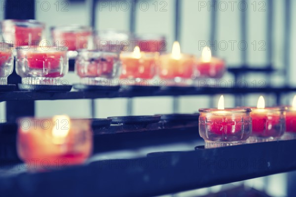 Close up of candles in old catholic church, blurry background