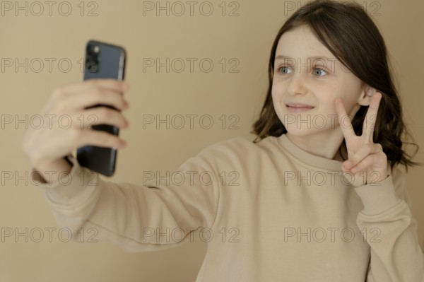 Girl, 10, takes a selfie with mobile phone