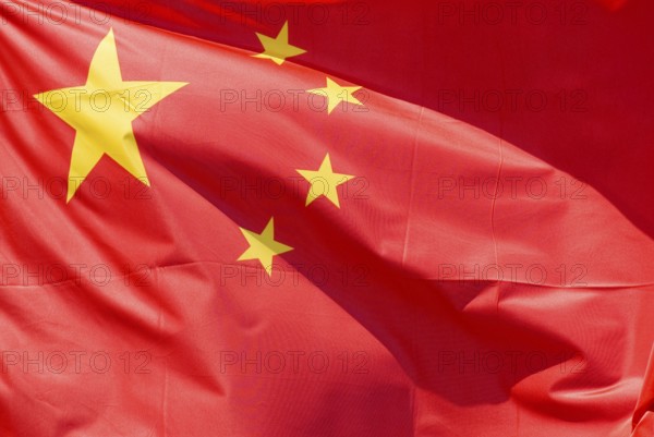 Closeup of the national flag of China flapping fluttering moving in the wind