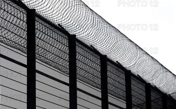 High fence and barbed wire, concertina wire, Nato barbed wire at Mainkofen District Hospital, Deggendorf, Lower Bavaria, Germany, Europe