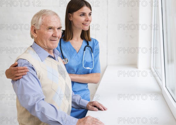 Caregiver old man looking window