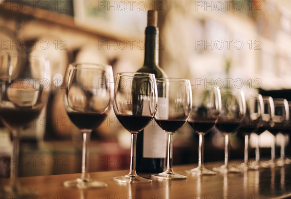 Wine bottle with glasses of red wine on wooden table