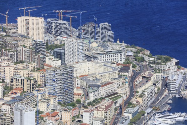 Monte-Carlo district with large construction site of the new Mareterra district built into the sea, previously called Anse du Portier, architect Renzo Piano and others with luxury properties for billionaires, on the right Port Hercule harbour, Principality of Monaco, seen from the Tete du Chien lookout mountain in La Turbie, Alpes-Maritimes department, Provence Alpes Cote d'Azur region, France, Mediterranean Sea, Europe