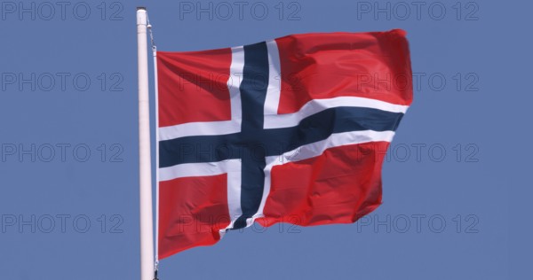 Norwegian Flag Waving in the Wind against blue sky
