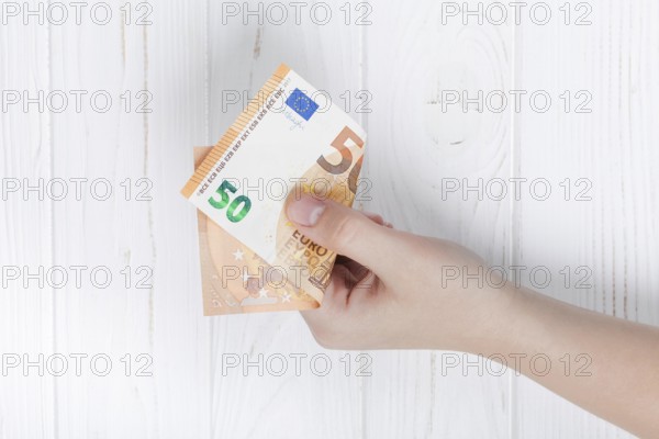 Hand holding euro bank note