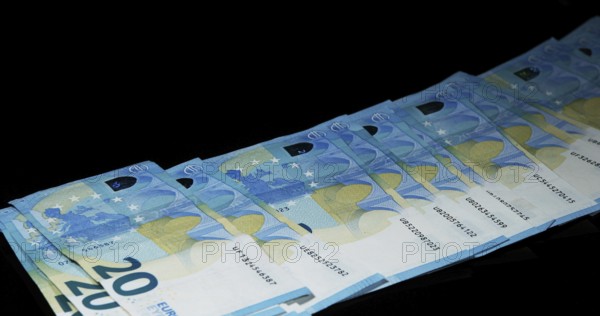 Euros Money Falling against Black Background