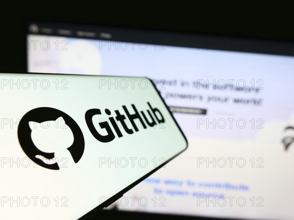 Stuttgart, Germany, 07-09-2023: Cellphone with logo of American software development company GitHub Inc. on screen in front of website. Focus on center-left of phone display, Europe