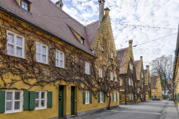 Building in the historic Fuggerei residential complex in the old town of Augsburg, Augsburg, Swabia, Bavaria, Germany, Europe
