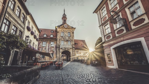 Sunrise through the gate of a historic building in a European old town, Bamberg's old town hall