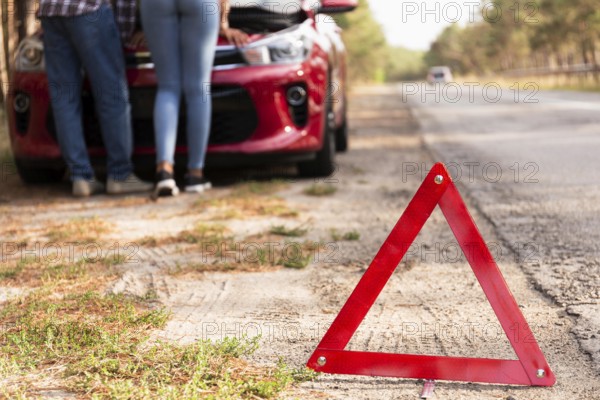 Red triangle sign road car problems while traveling