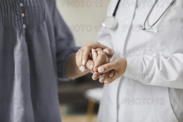 Covid recovery center female doctor holding elderly patient s hands. High resolution photo